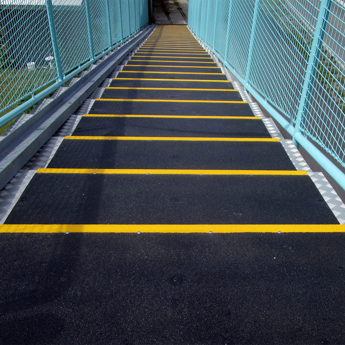 Landing cover installed on stairway platform to improve footing in high-traffic areas