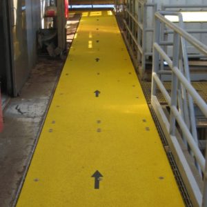 Anti-slip walkway covers mounted on steel gratings.